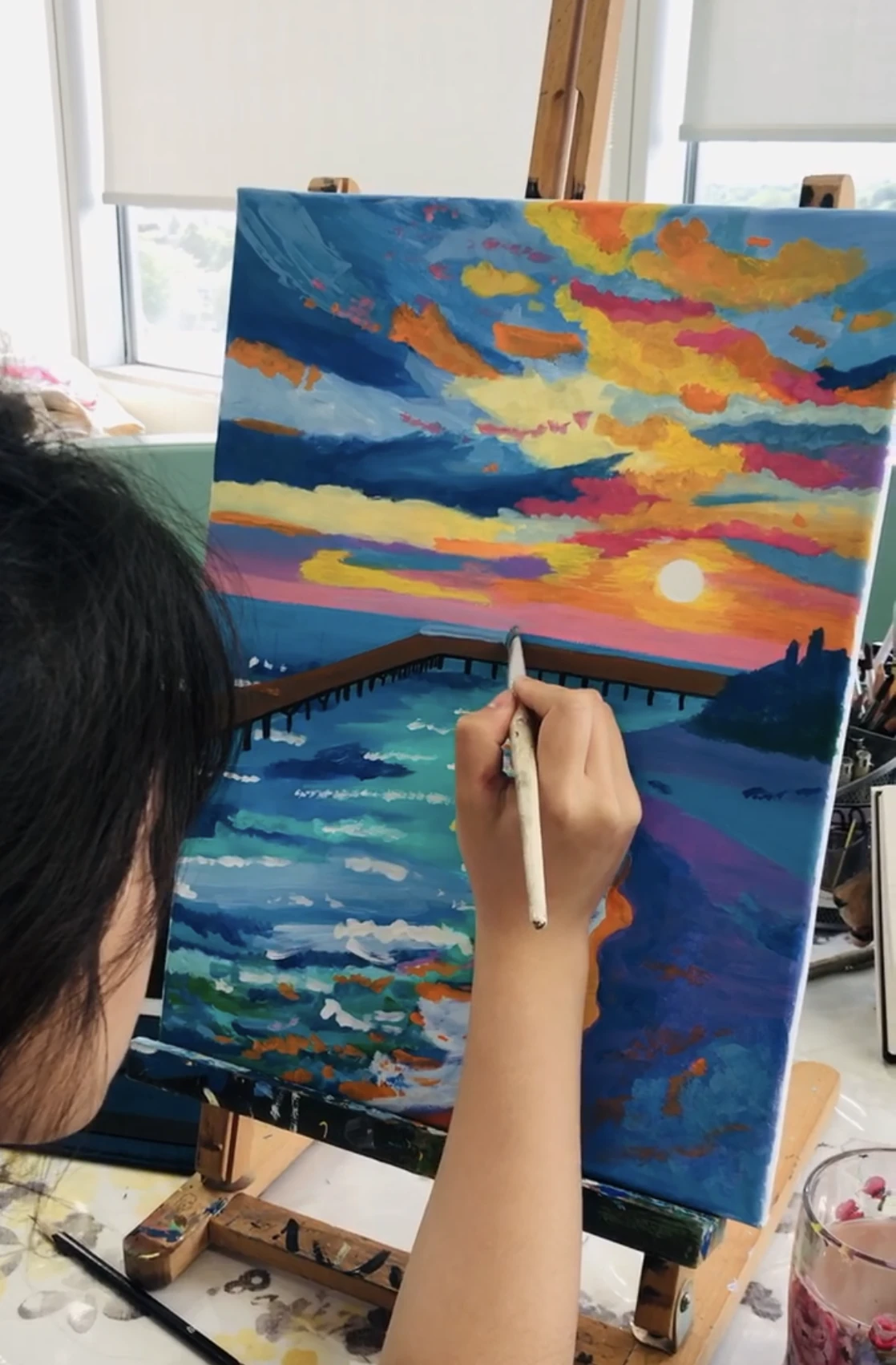 Girl painting at an easel